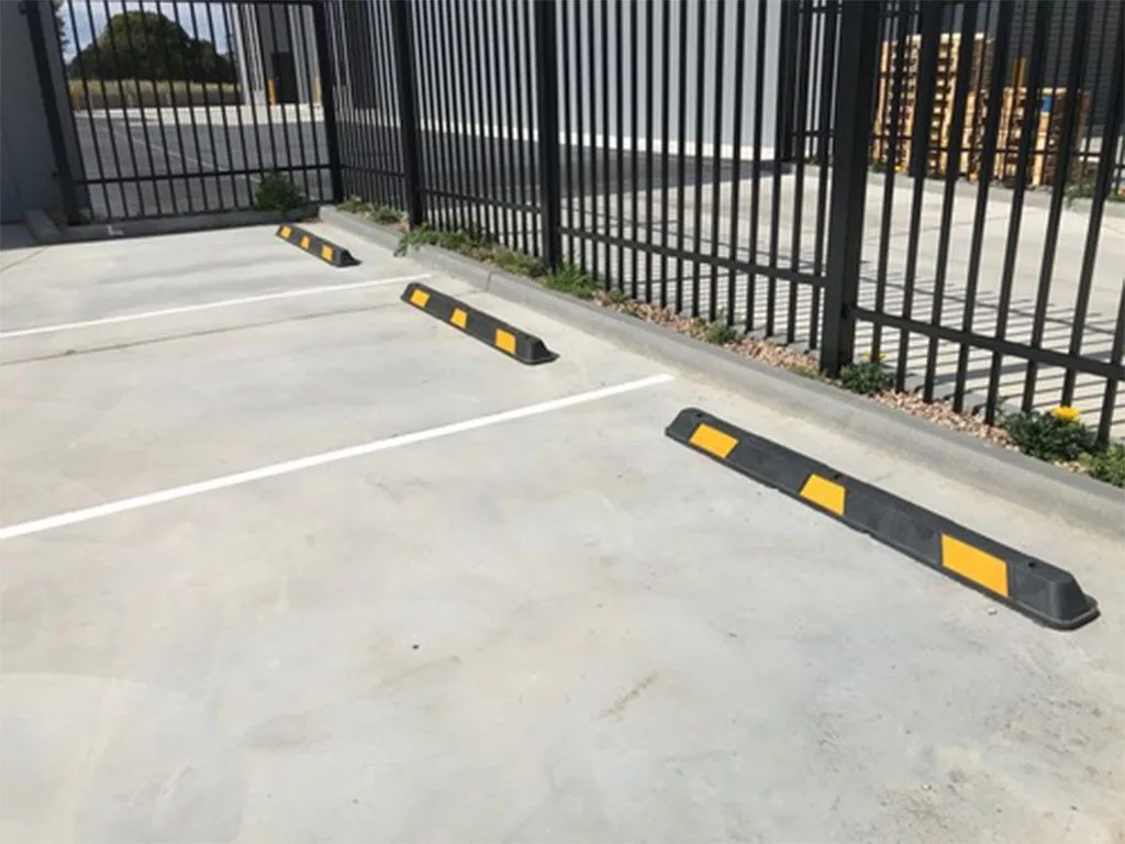 Row of rubber wheel stops marking parking bays